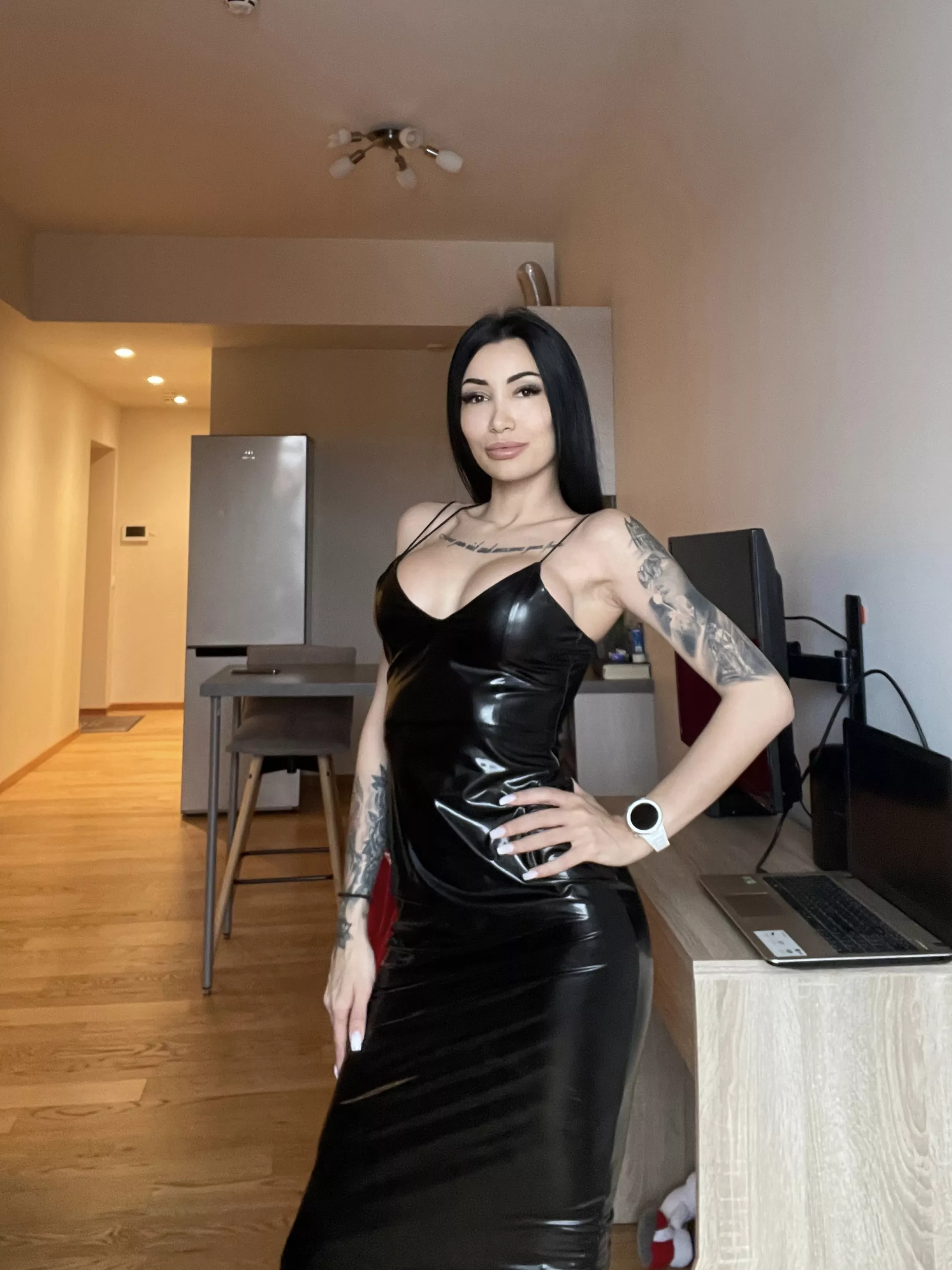 Stunning brunette in a black leather dress